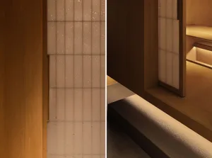 Bathroom with tiled walls, wooden doorframe, and brownish tiles in a dimly lit space