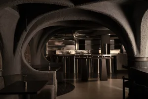 Cozy restaurant interior with stone walls, circular design, and comfortable seating for guests