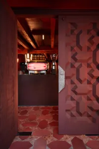 A warm and inviting kitchen area in a restaurant with two coffee makers, a refrigerator, and a sink, designed for customer convenience