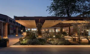 Inviting restaurant interior with wooden structure, potted plants, and multiple benches