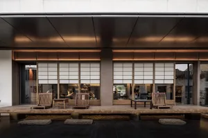 Asian restaurant with wooden furniture and a patio area, featuring sliding doors and a warm, inviting atmosphere