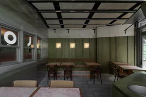 Warm and inviting cafe interior with wooden walls, marble tables, and comfortable seating