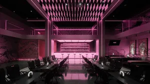 Modern restaurant interior with pink walls and flooring, featuring multiple chairs and tables in a stylish setting