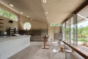 Inviting restaurant and store interior with a counter, chairs, and bottles on display