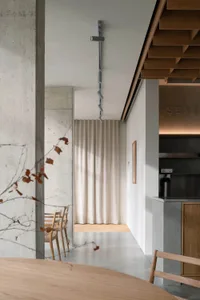 Open living space with a kitchen, dining area, and two chairs, featuring a clean and well-organized atmosphere