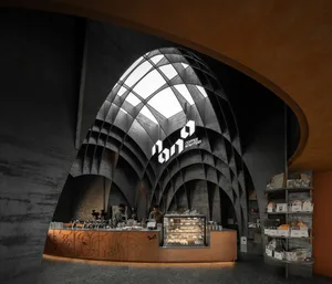 Inviting cafe interior with a counter, wooden accents, and a person serving beverages