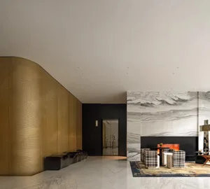 Sophisticated living space with a checkered rug, black and gold walls, two couches, chairs, and a fireplace