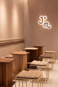 A dimly lit restaurant interior with wooden tables and chairs, creating a cozy atmosphere