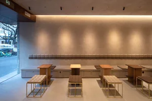 A large room with multiple dining tables and chairs, benches, and a spacious atmosphere suitable for social gatherings and events
