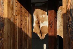 Rustic coffee shop interior with leather door hides, wooden doors, and a traditional design theme