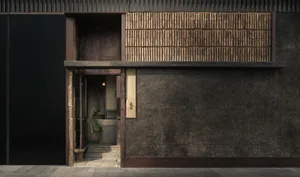 A dark interior with a wooden doorway flanked by two potted plants, inviting viewers inside with an air of mystery and intrigue