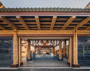 Open social space with wooden walls and ceiling, people walking and conversing