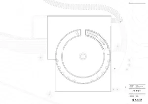 Empty modern building with a circular design on its side, featuring a large circular element in one corner, with ample natural light