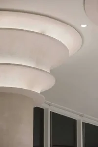 A modern white building featuring a spiral staircase with a clean and contemporary design, creating a calm and serene atmosphere