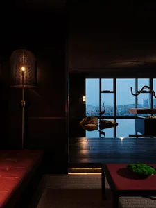 Modern living room with a black and white theme, featuring a large window with a city view, two couches, a dining table, and chairs