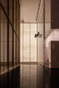 Empty modern lobby with a marble floor and white walls, giving a clean and minimalist appearance