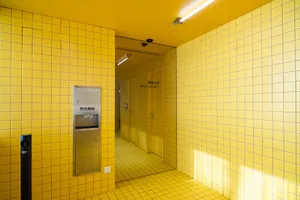 A retro bathroom with two sinks, ceramic tile walls and floor, and a classic design