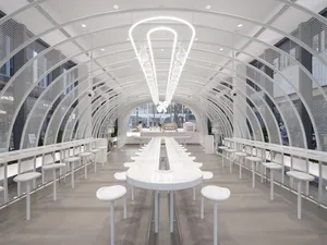 A bright and inviting dining area with multiple white tables and chairs, designed for social gatherings or events