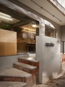 Modern building exterior with concrete stairs, brick facade, and clean lines