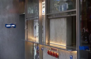Industrial kitchen with a countertop featuring multiple red fire extinguishers and a utilitarian atmosphere