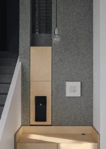 Modern kitchen with a black refrigerator, artwork on the walls, and a stylish atmosphere