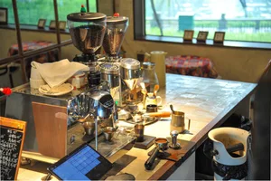A well-equipped kitchen with a wooden table, various appliances, and kitchenware on the countertop