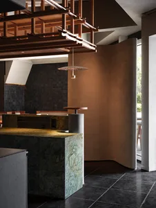 Modern restaurant dining area with a marble countertop, chairs, and a dining table, featuring warm and inviting lighting
