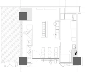 Modern kitchen and dining area with countertops, cabinets, appliances, and seating, featuring bottles and a functional layout