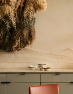 A clean and organized kitchen counter with bowls and cups on display, showcasing a focus on functionality and aesthetics