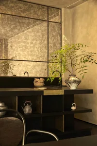A clean and organized bathroom with two sinks, potted plants, vases, and toiletries, featuring a focus on functionality and aesthetics