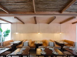 Warm and inviting restaurant interior with wooden tables and chairs, rustic charm, and a focus on comfort and functionality