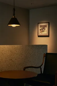 Dimly lit room with two chairs and stone-like walls creating a cozy atmosphere