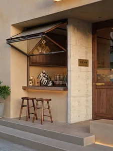 Cozy bar area with stone counter, wooden stools, and various items on display