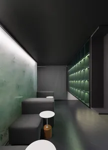 Dimly lit room with two couches, three chairs, and a black ceiling and walls