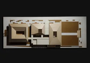 Architectural model of a grand wooden building with multiple rooms, windows, and detailed design elements