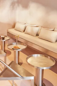 A modern living space with two couches, a dining table, and chairs, featuring neutral tones, clean lines, and a cozy atmosphere