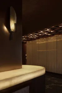 Darkly lit kitchen or dining area with a central countertop, sink, and two side lights