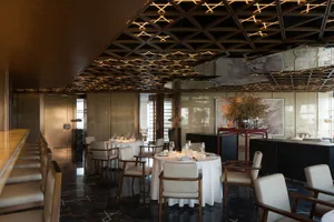 Sophisticated restaurant interior with wooden furniture, wine glasses, and a warm atmosphere