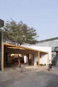 Casual open concept living area with a dining table, two chairs, and a bicycle parked outside