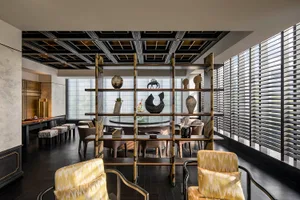 A well-lit dining area with multiple chairs, a dining table, and decorative vases on shelves, showcasing various styles and designs