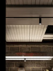 Industrial interior with metal ceiling, variously positioned lights, and a functional yet stylish atmosphere