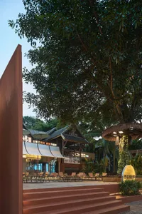 A patio area with chairs and dining tables, creating a comfortable outdoor space for socializing and relaxation