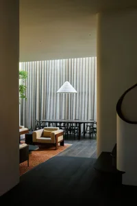 A dining room with a table and chairs, a couch, and a cozy atmosphere for socializing and meals