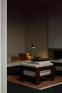 Cozy living area with a sofa and armchair, a table, and a warm atmosphere