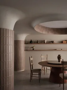 A warm and inviting dining space with a wooden table surrounded by chairs and decorative vases