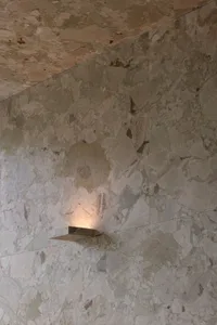 A marble wall with a stone design in a bathroom, part of an old building, exuding luxury and elegance