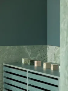 A clean bathroom with a countertop featuring decorative blocks and bottles, showcasing a focus on functionality and aesthetics