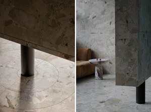 Elegant living space with two couches, a marble dining table, and sophisticated atmosphere