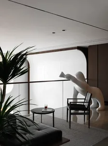 A cozy living area with a white bear statue on a wooden chair, a dining table, and a potted plant, creating a warm and inviting atmosphere
