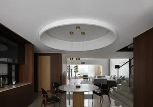 Cozy open living area with a dining table, two couches, a potted plant, and a vase on the table, surrounded by modern interior design elements